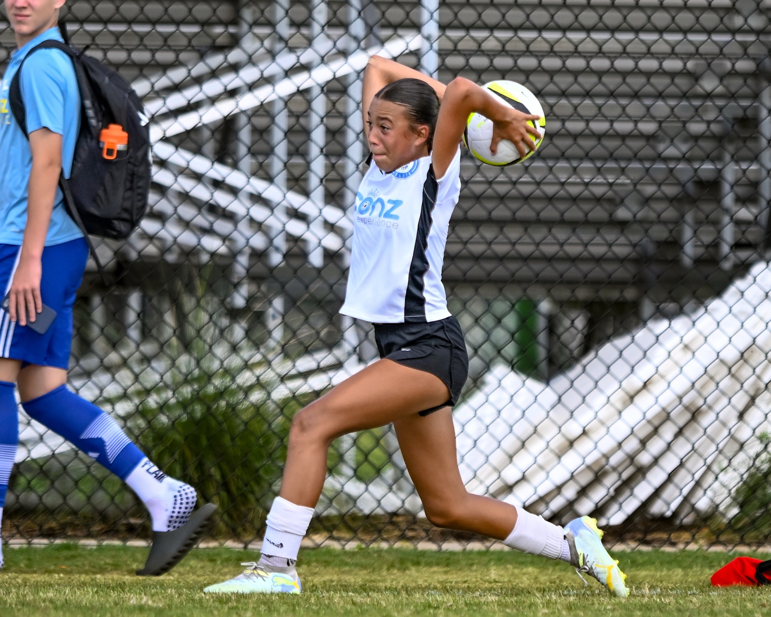 Pierce Jackson in a white kit taking a throw-in during a match.